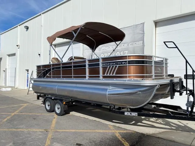 Slide: The Image of 2023 Bennington 22LFAPG pontoon boat on a trailer outside a warehouse. - 13