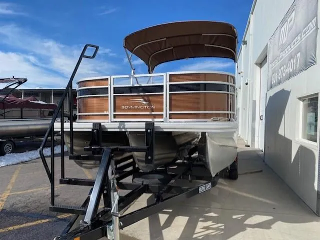 Slide: The Image of 2023 Bennington 22LFAPG pontoon boat on a trailer outside a dealership. - 14