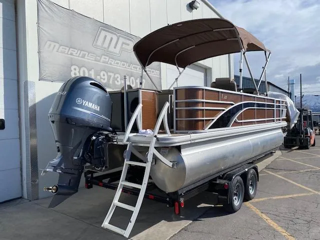 Slide: The Image of 2023 Bennington 22LFAPG pontoon boat with Yamaha outboard motor on trailer. - 3