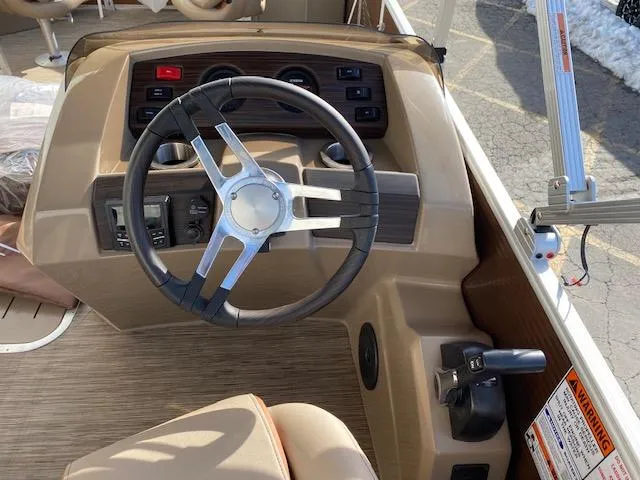 Slide: The Image of 2023 Bennington 22LFAPG boat dashboard with steering wheel and control panel. - 5