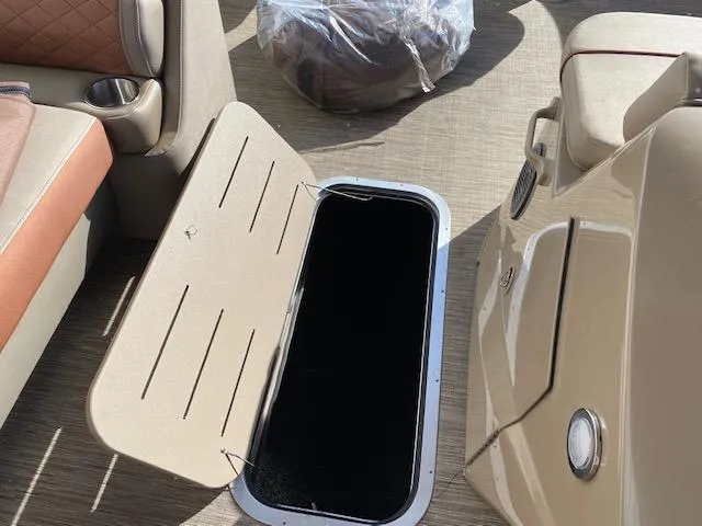 Slide: The Image of 2023 Bennington 22LFAPG boat interior with open storage compartment. - 9