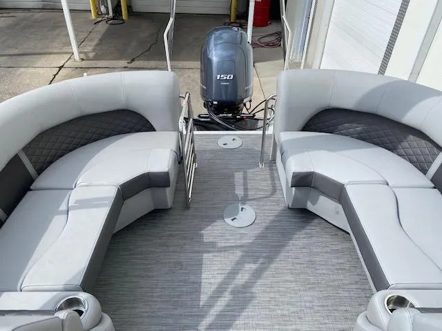 Slide: The Image of 2023 Bennington 22LFB pontoon boat interior with seating and 150 HP outboard motor. - 10
