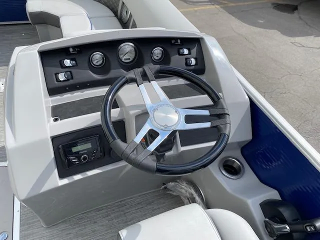 Slide: The Image of 2023 Bennington 22LFB boat dashboard with steering wheel and control panel. - 6