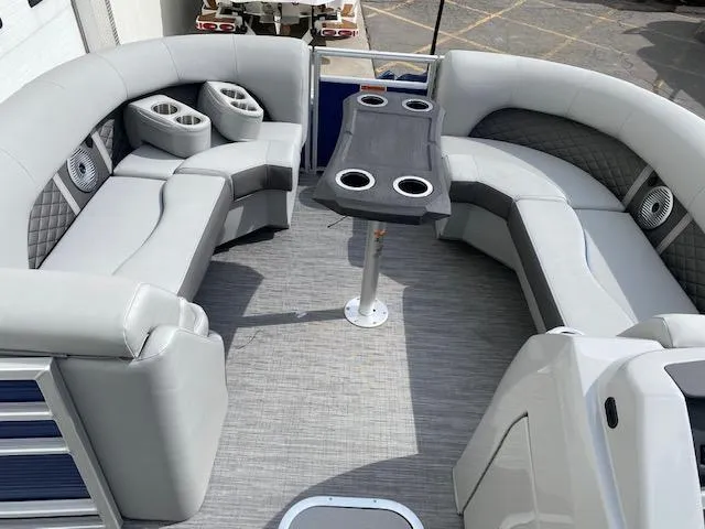 Slide: The Image of 2023 Bennington 22LFB pontoon boat interior with gray seating and table. - 7