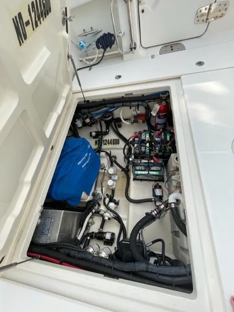 Slide: The Image of 2012 Boston Whaler 370 Outrage engine compartment with equipment and wiring. - 14
