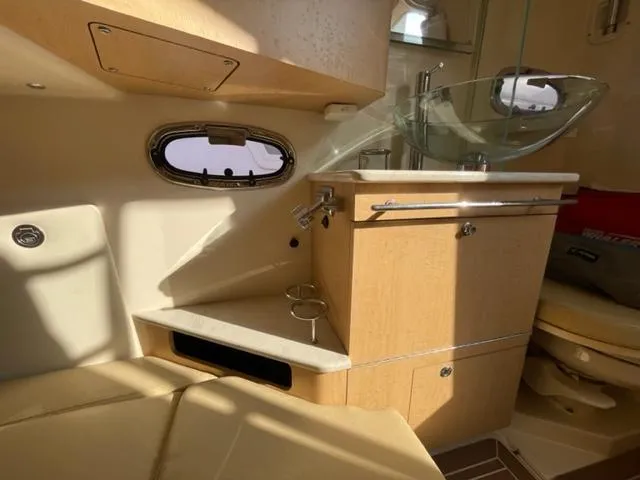 Slide: The Image of Interior of 2012 Boston Whaler 370 Outrage, featuring modern sink and cabinetry. - 16
