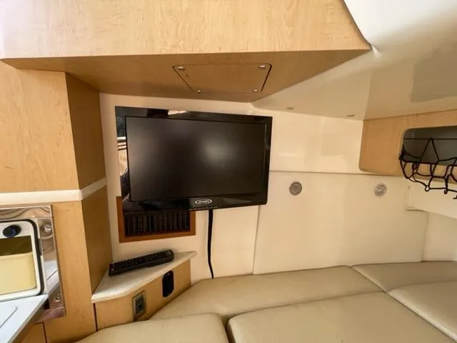 Slide: The Image of Interior of 2012 Boston Whaler 370 Outrage with TV and seating area. - 19
