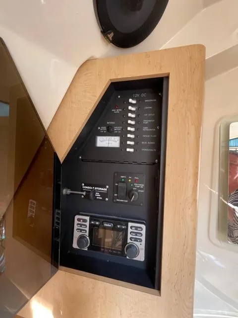 Slide: The Image of Electrical panel of a 2012 Boston Whaler 370 Outrage boat, featuring control switches and displays. - 20