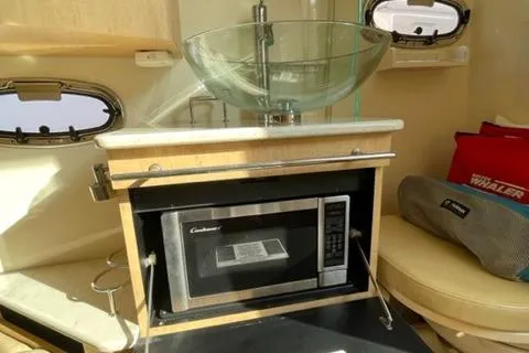 Slide: The Image of 2012 Boston Whaler 370 Outrage interior with glass sink and microwave. - 22