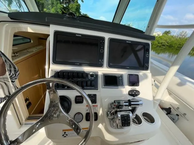 Slide: The Image of 2012 Boston Whaler 370 Outrage helm with dual screens and controls. - 6