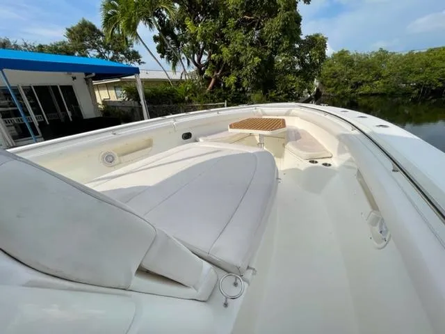 Slide: The Image of 2012 Boston Whaler 370 Outrage boat with spacious deck and seating area. - 7