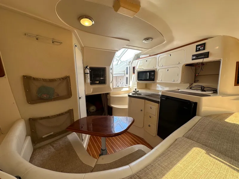 Slide: The Image of 2003 Grady-White 330 Express cabin interior with kitchenette and seating area. - 13
