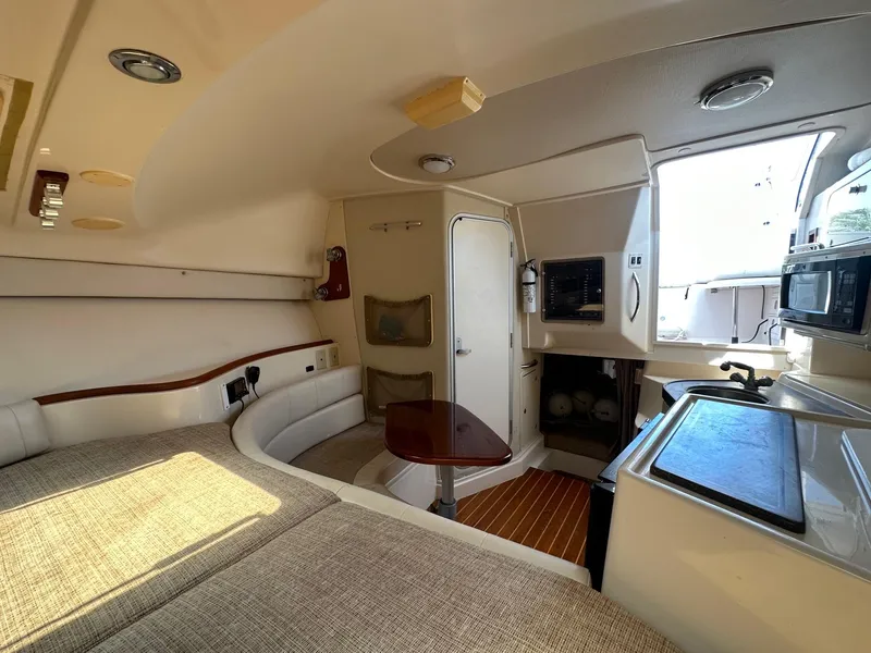 Slide: The Image of Interior of 2003 Grady-White 330 Express boat with seating, table, and kitchenette. - 14