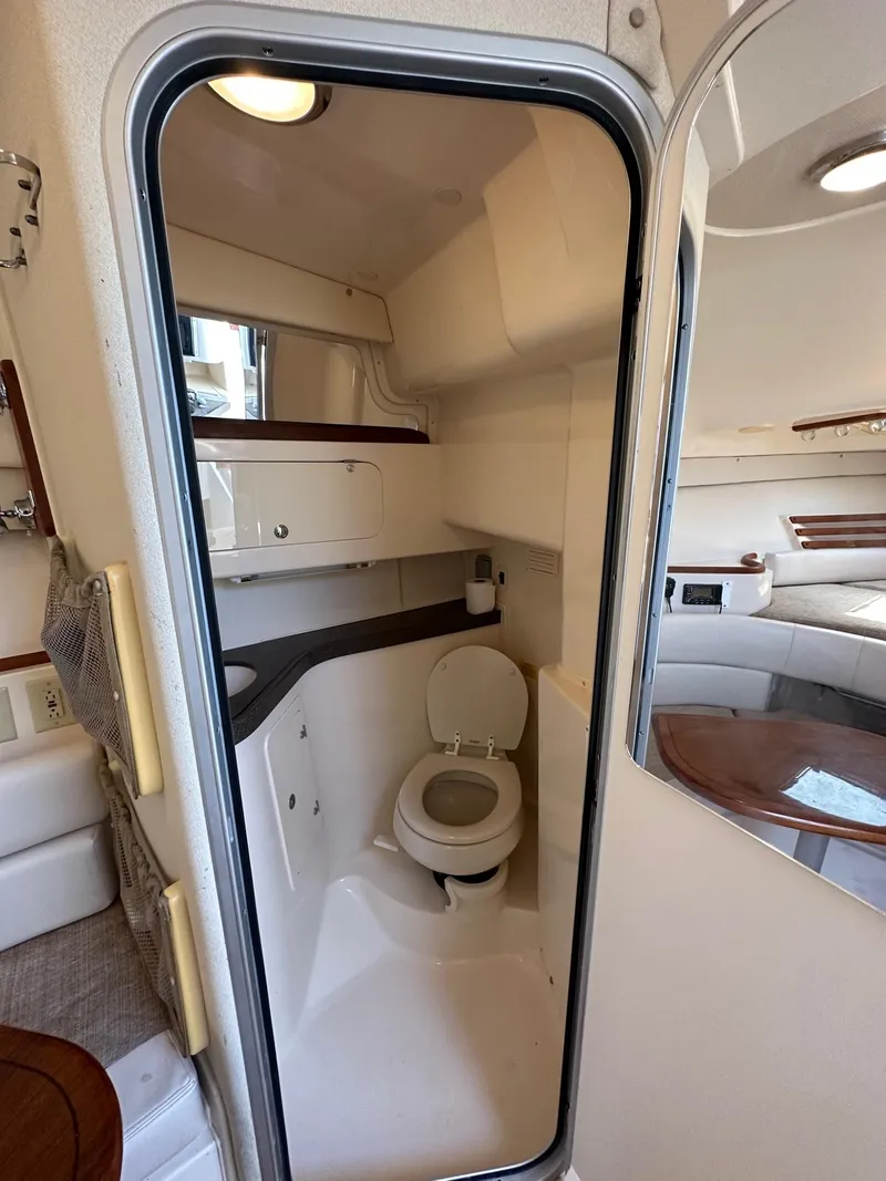 Slide: The Image of 2003 Grady-White 330 Express boat interior bathroom with toilet and sink. - 15