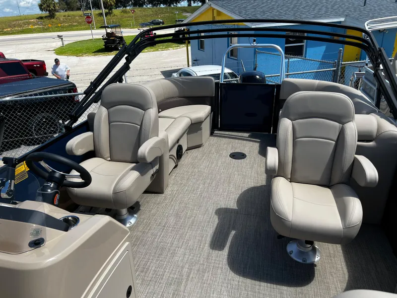 Slide: The Image of 2024 Bentley Pontoons Fish 20 interior with beige seating and steering console. - 10