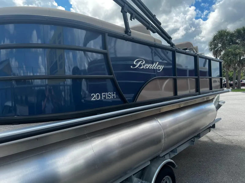 Slide: The Image of 2024 Bentley Pontoons Fish 20 boat with sleek design and blue exterior. - 3