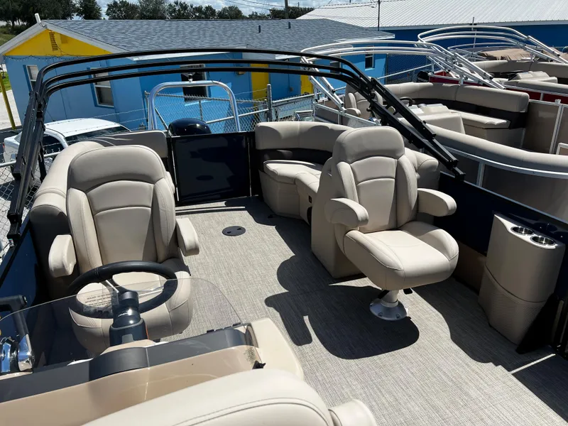 Slide: The Image of 2024 Bentley Pontoons Fish 20 interior with beige seating and steering wheel. - 7