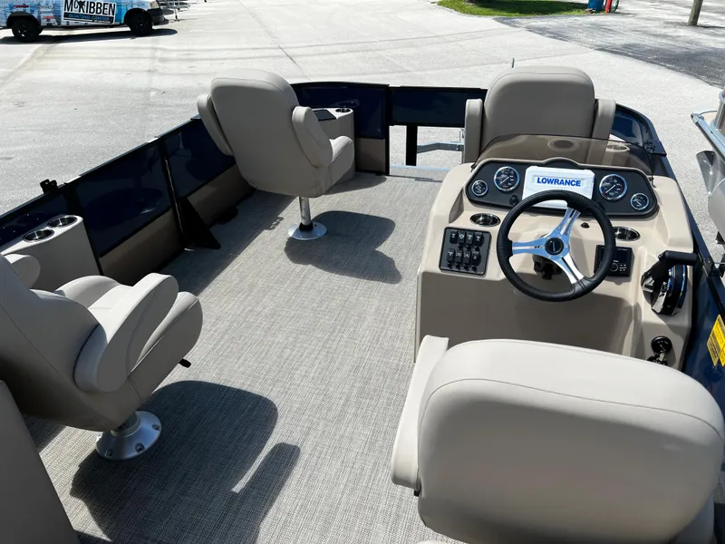 Slide: The Image of 2024 Bentley Pontoons Fish 20 interior with beige seating and steering console. - 8