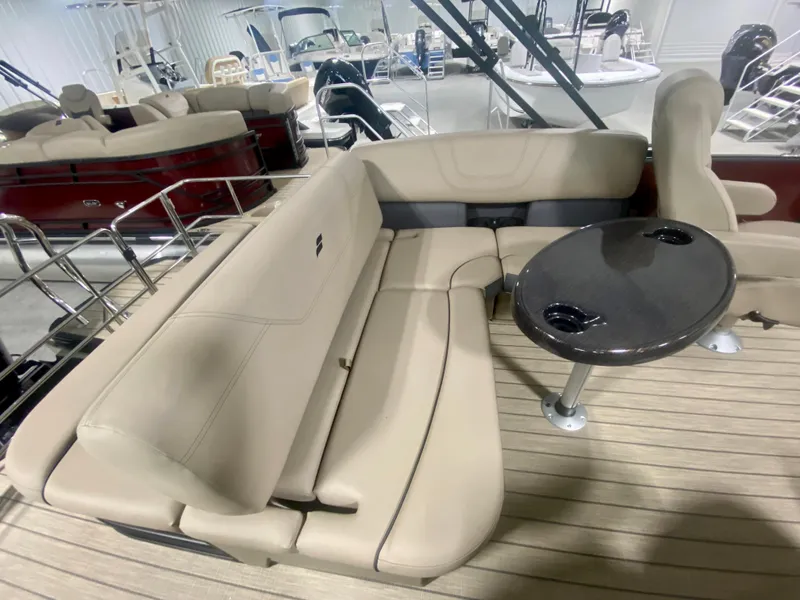 Slide: The Image of 2024 Starcraft SLS 3 Q DH boat interior with beige seating and a small table. - 12