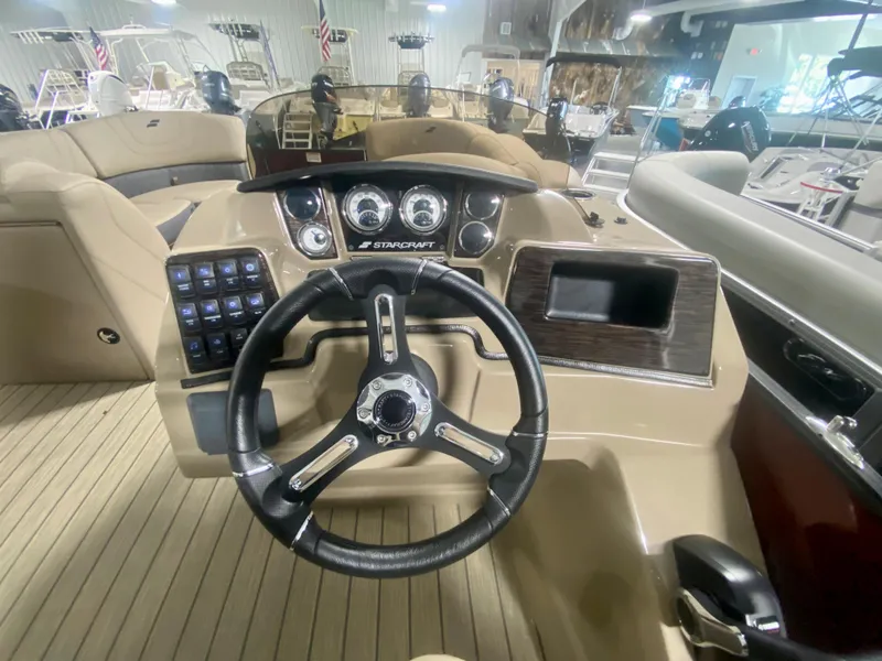 Slide: The Image of 2024 Starcraft SLS 3 Q DH boat dashboard with steering wheel and control panel. - 20