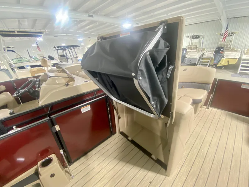 Slide: The Image of 2024 Starcraft SLS 3 Q DH boat interior with folded canopy in showroom. - 22