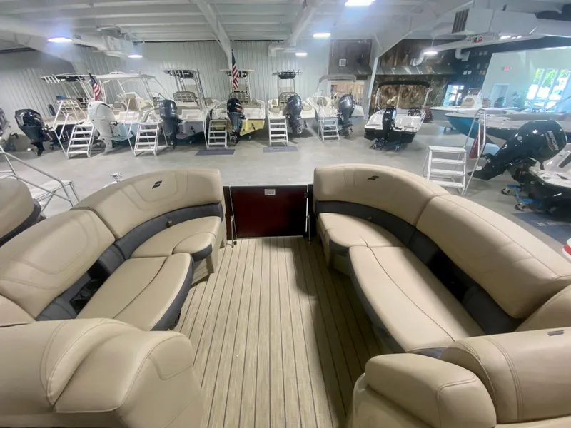Slide: The Image of 2024 Starcraft SLS 3 Q DH pontoon boat interior with beige seating in showroom. - 27