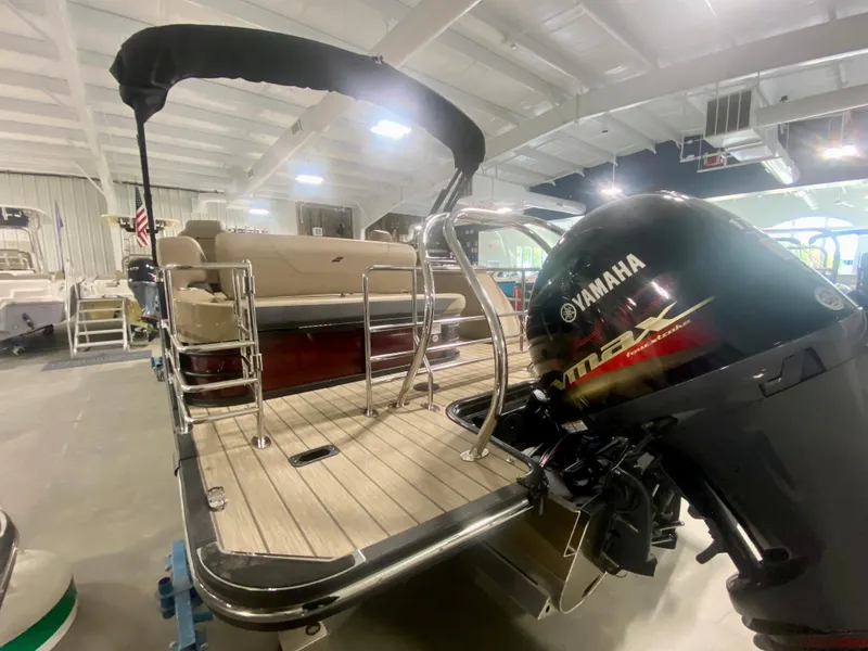 Slide: The Image of 2024 Starcraft SLS 3 Q DH pontoon boat with Yamaha outboard motor in showroom. - 5