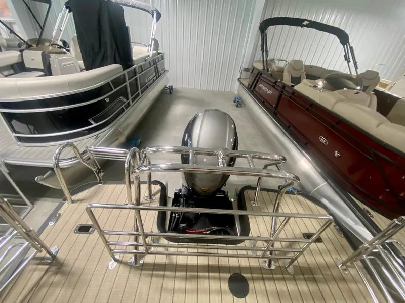 Slide: The Image of 2024 Starcraft SLS 3 Q DH pontoon boat with outboard motor in showroom. - 6