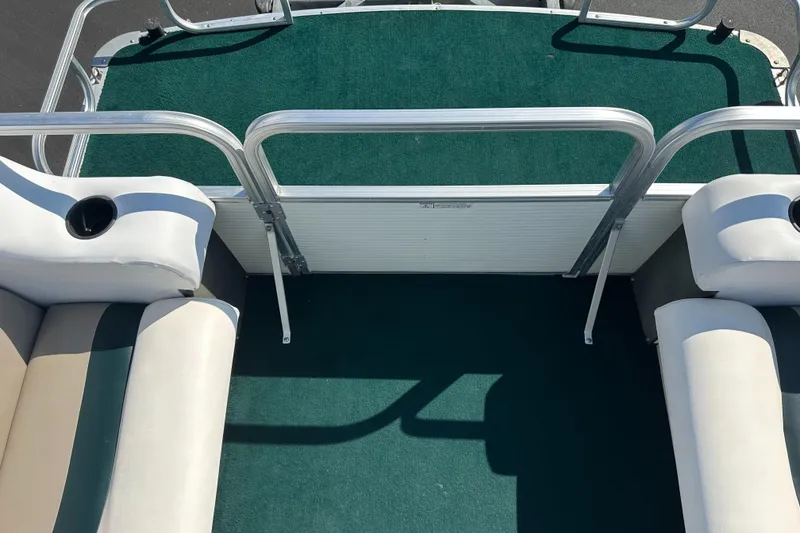 Slide: The Image of 1998 Suncruiser 240 Trinidad boat interior with green carpet and white seating. - 10