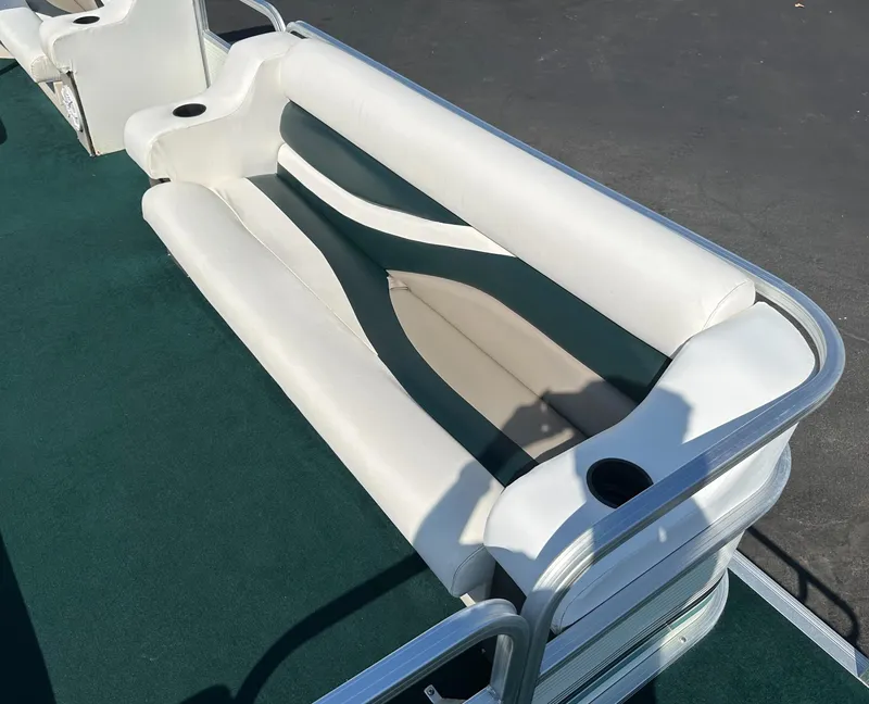 Slide: The Image of 1998 Suncruiser 240 Trinidad boat seating with white upholstery and cup holders. - 13