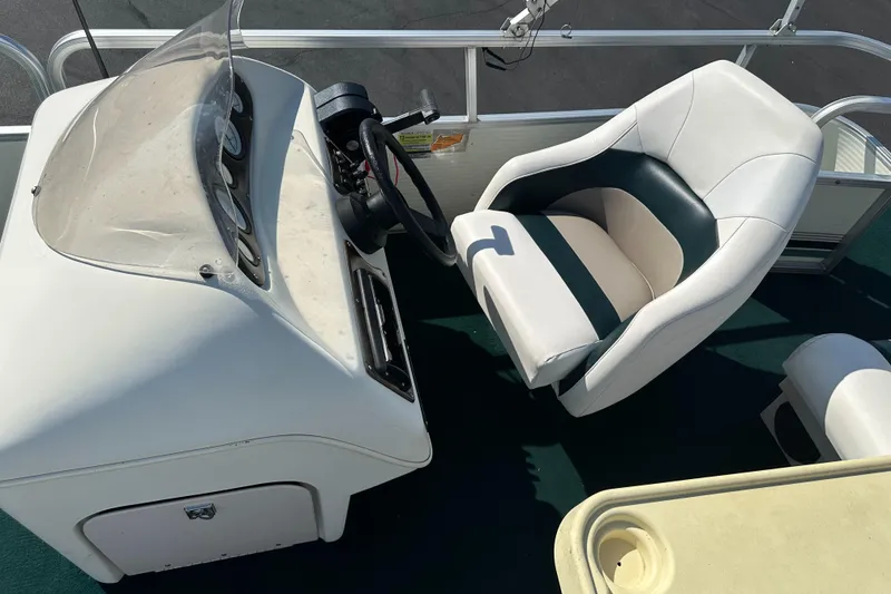Slide: The Image of 1998 Suncruiser 240 Trinidad boat interior with steering console and seating. - 16