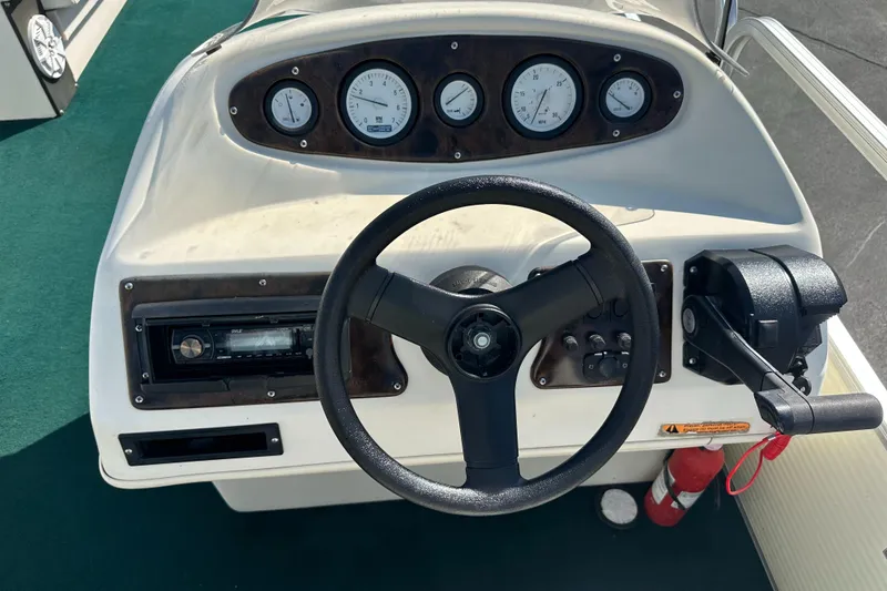 Slide: The Image of 1998 Suncruiser 240 Trinidad boat dashboard with steering wheel and gauges. - 17