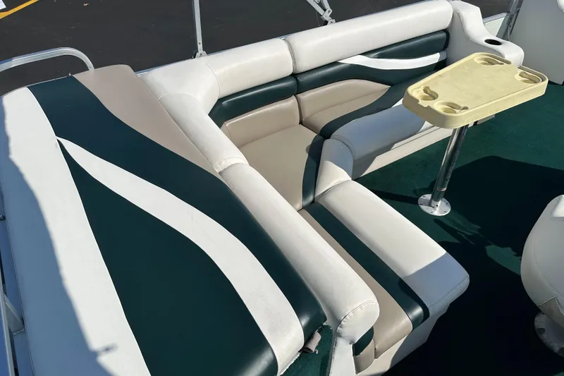 Slide: The Image of 1998 Suncruiser 240 Trinidad boat interior with green and white seating and a small table. - 19