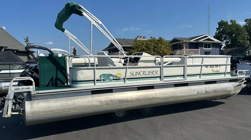 Slide: The Image of 1998 Suncruiser 240 Trinidad pontoon boat parked on a driveway. - 2