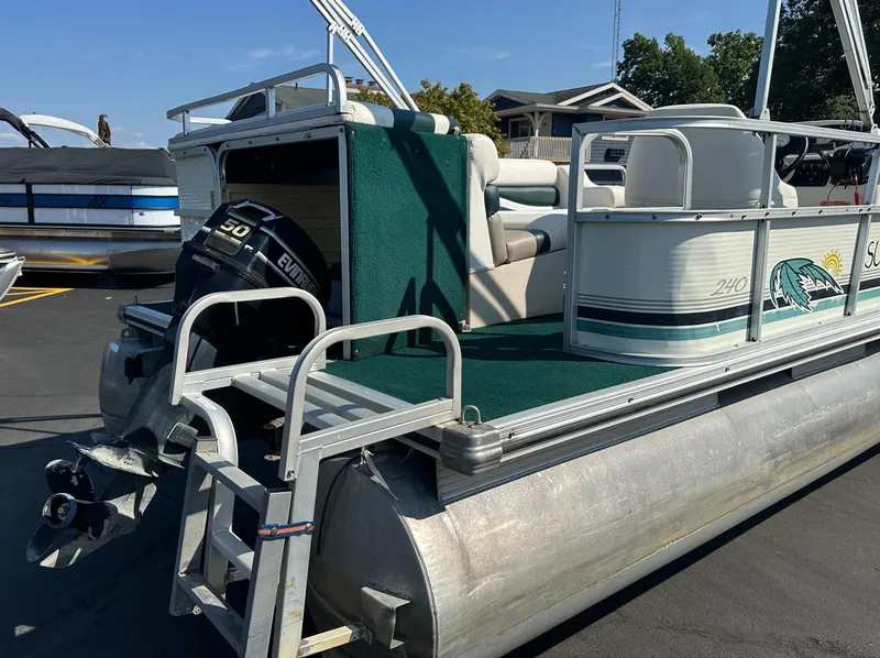 Slide: The Image of 1998 Suncruiser 240 Trinidad pontoon boat with Evinrude motor, docked on a sunny day. - 3
