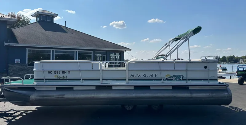 Slide: The Image of 1998 Suncruiser 240 Trinidad pontoon boat parked near a marina. - 5
