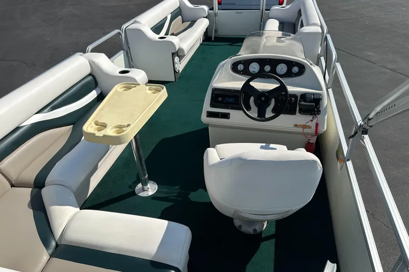 Slide: The Image of 1998 Suncruiser 240 Trinidad pontoon boat interior with seating and steering console. - 9