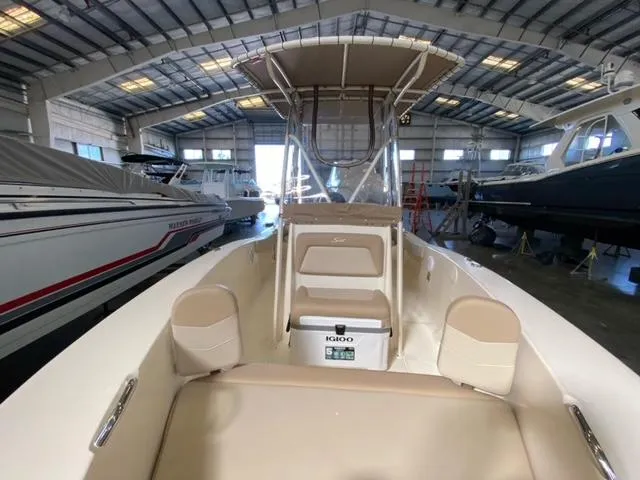 Slide: The Image of 2024 Scout 195 Sportfish boat in a spacious indoor marina setting. - 7