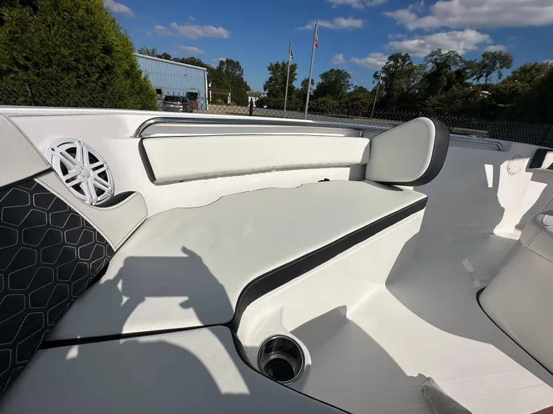 Slide: The Image of 2024 Tidewater 210 CC Adventure boat with white cushioned seating and cup holder. - 12