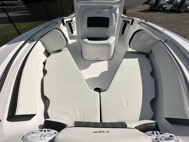 Slide: The Image of 2024 Tidewater 210 CC Adventure boat interior with cushioned seating. - 13