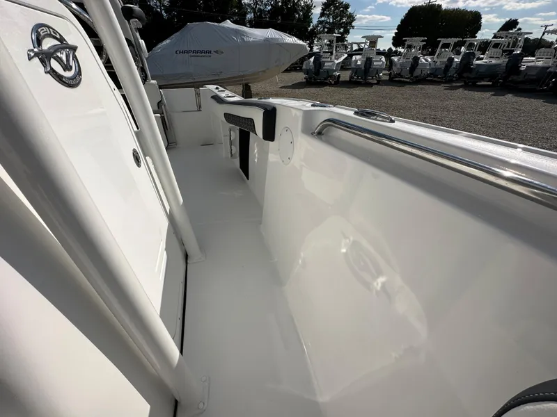 Slide: The Image of 2024 Tidewater 210 CC Adventure boat deck with white interior and stainless steel railing. - 19