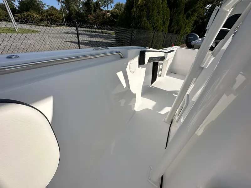 Slide: The Image of 2024 Tidewater 210 CC Adventure boat interior, white deck and seating. - 20