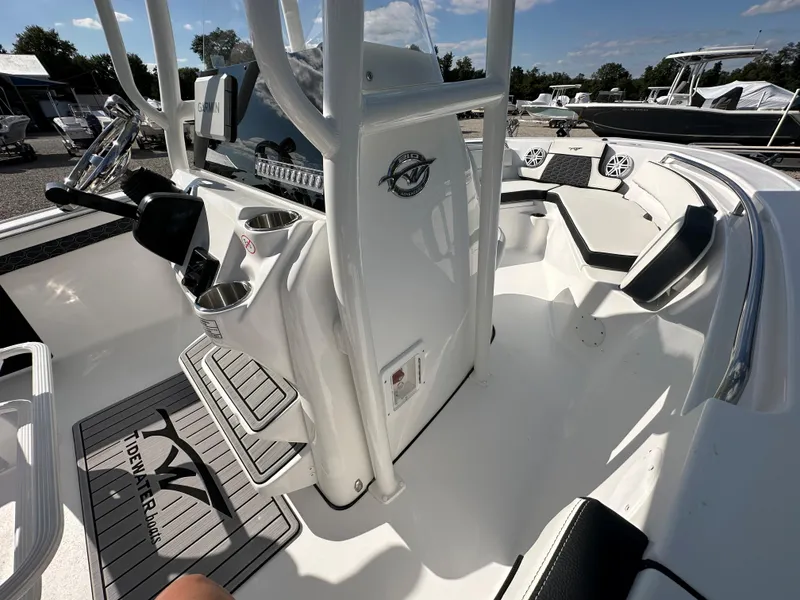 Slide: The Image of 2024 Tidewater 210 CC Adventure boat interior with console and seating. - 23