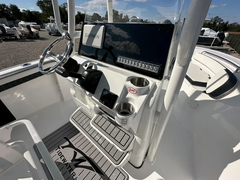 Slide: The Image of 2024 Tidewater 210 CC Adventure boat console with Garmin electronics and cup holders. - 25