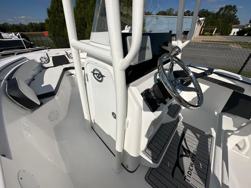 Slide: The Image of 2024 Tidewater 210 CC Adventure boat cockpit with steering wheel and console. - 27