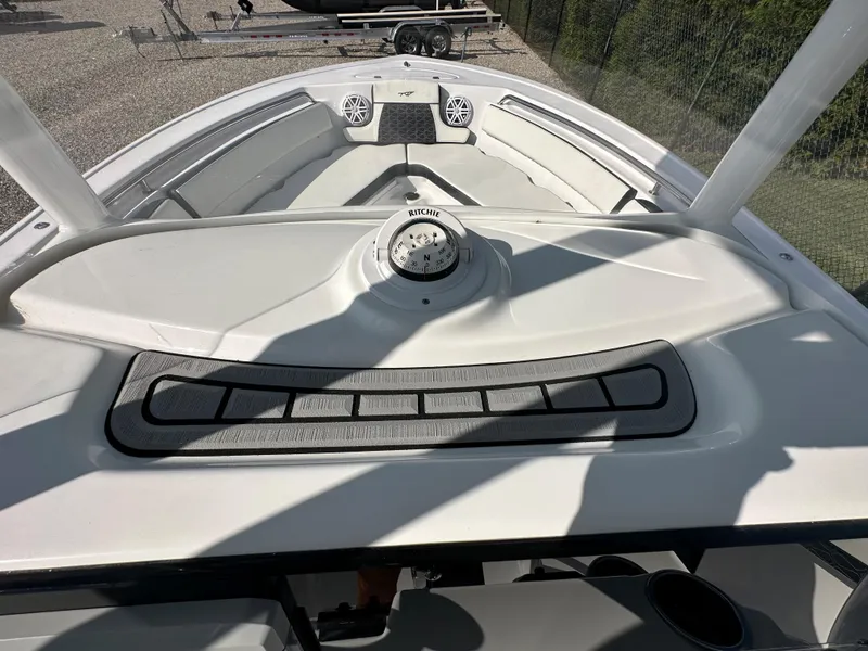 Slide: The Image of 2024 Tidewater 210 CC Adventure boat deck with compass and speakers. - 30