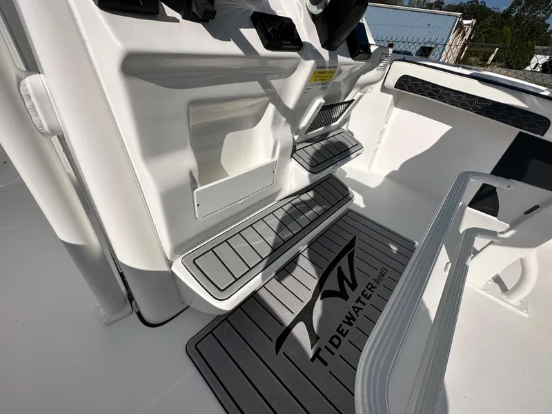 Slide: The Image of 2024 Tidewater 210 CC Adventure boat interior with branded floor mat and step details. - 33
