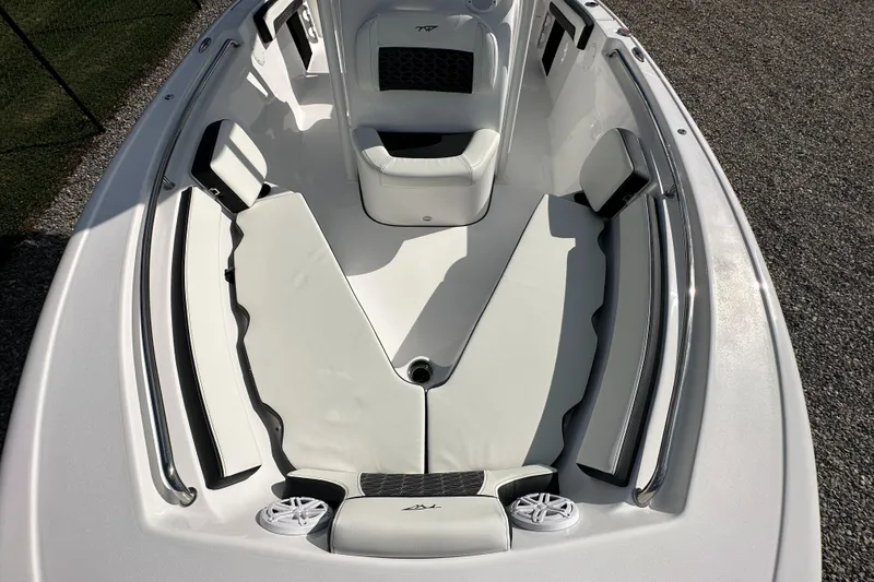 Slide: The Image of 2024 Tidewater 210 CC Adventure boat interior with cushioned seating. - 9