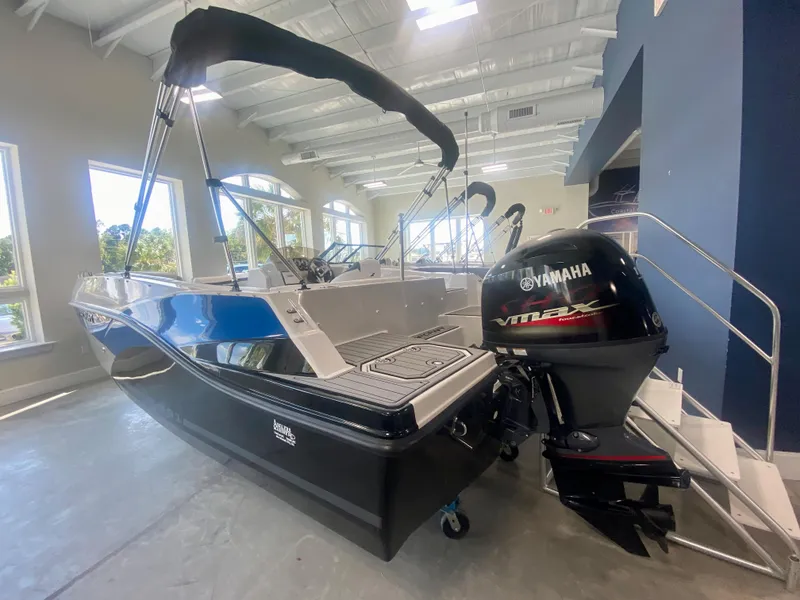 Slide: The Image of 2024 Starcraft SVX 191 boat with Yamaha outboard motor in showroom. - 2
