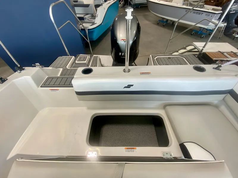 Slide: The Image of 2024 Starcraft SVX 191 boat interior with storage compartment and outboard motor. - 8
